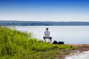 Man sitting down and summer fishing