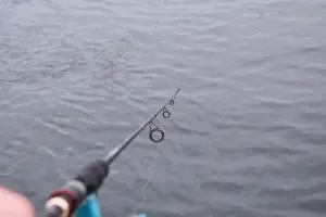 A Fishing rod, spinning reel on the river background