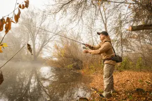 Fisherman with spinning on the river bank