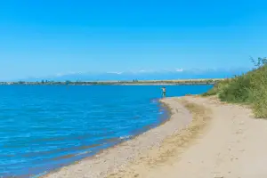 A man with a fishing reel on the lake