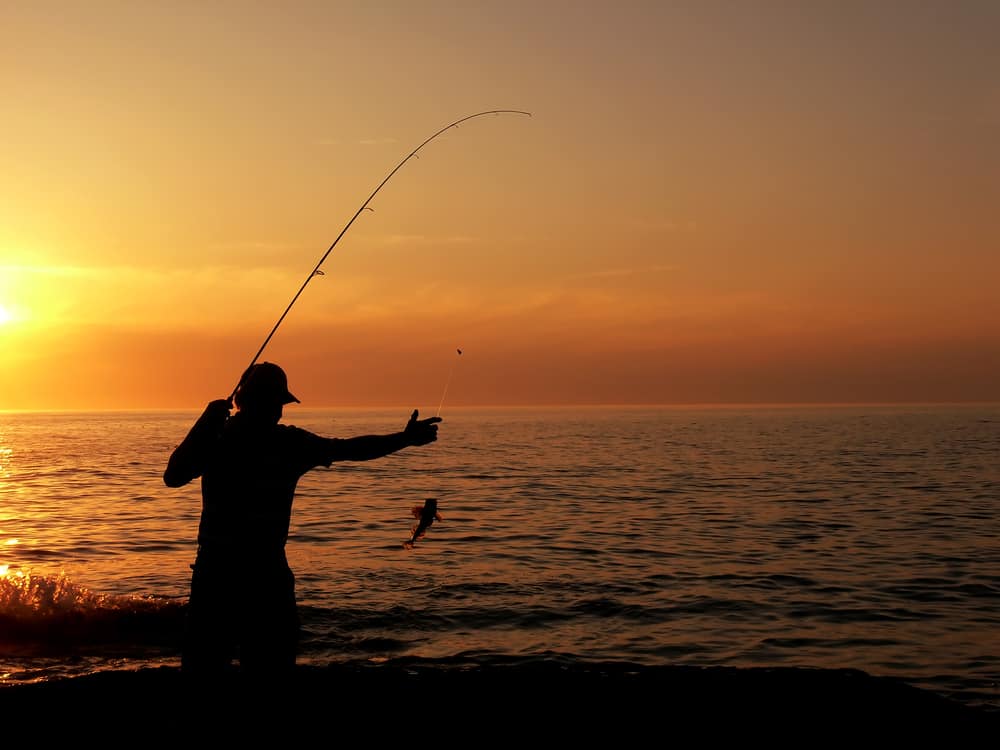 Man fishing at dusk