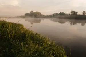 Fishing at foggy lake in the early morning