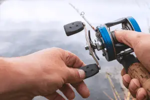 Man is fishing with a backcasting reel