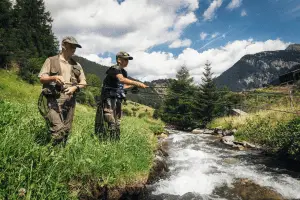 father and son fishing by the river