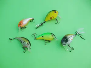 different types of crankbaits laid out on a green table