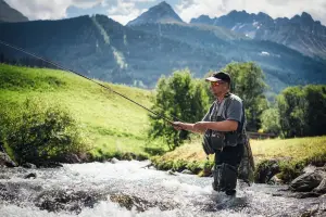 man fishing in a mountain river