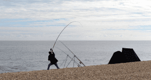 man throwing a fishing line into the water
