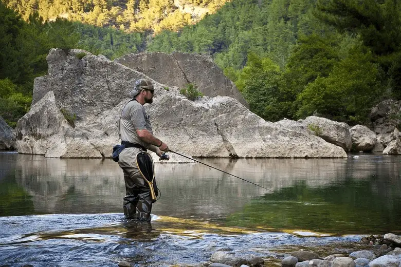 angler fishing in a mountain river