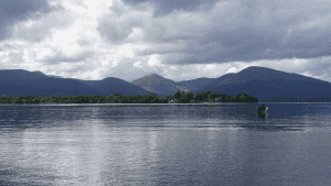 angler in a fishing boat in the middle of the lake