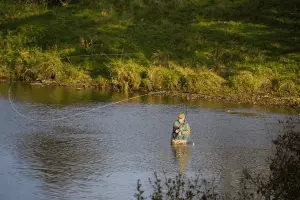 angler fishing in the middle of a river
