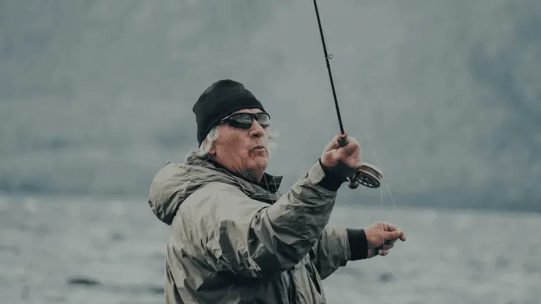 senior citizen throwing a fishing bait into the water