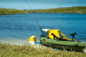 green inflatable fishing boat near the lake shore