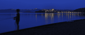 little boy fishing at night from the shore