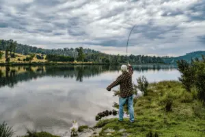 angler fishing near the river on a cloudy day