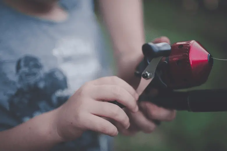 close-up of setting up a spinning reel drag