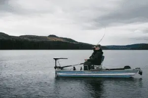 old man in a fishing boat trolling for trout