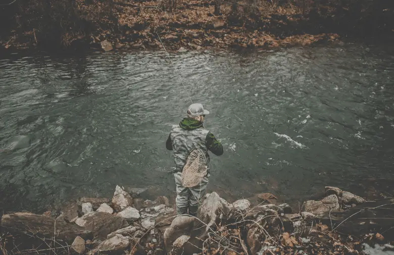 top view of angler fishing by the river