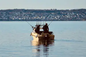 anglers on a fishing boat in the middle of the lake
