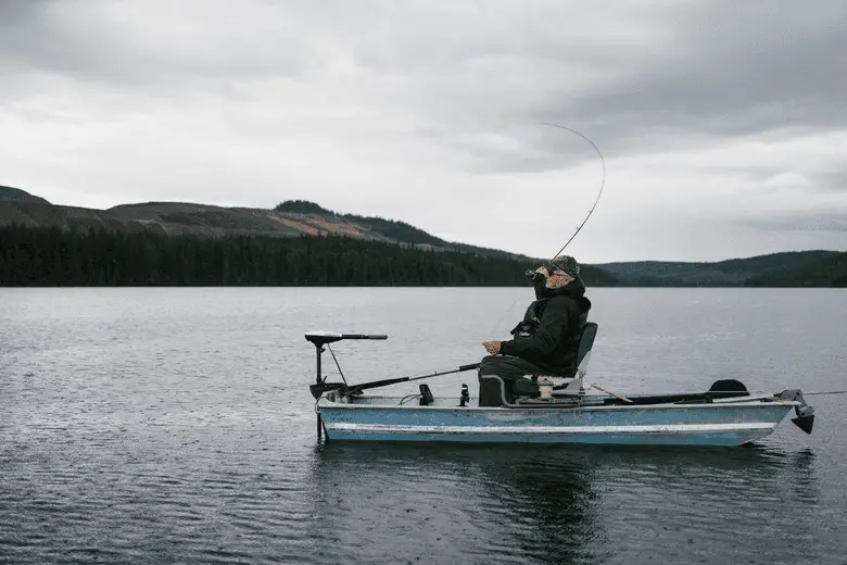 fisherman throwing a bait from his boat