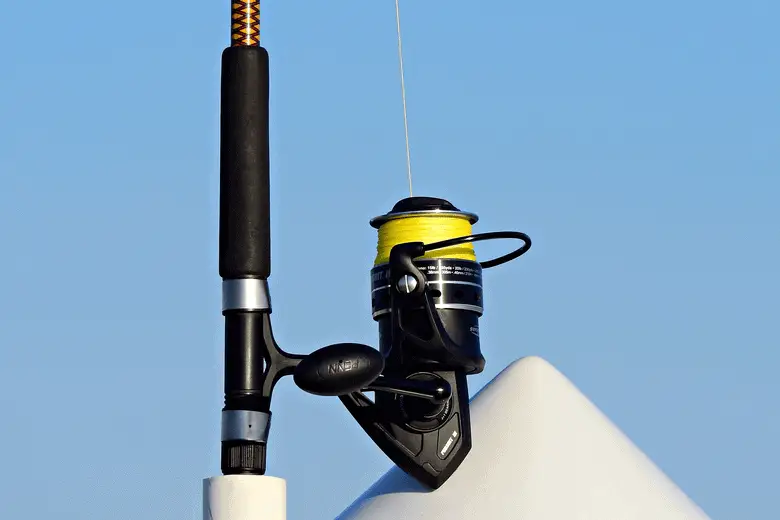 close-up shot of a spinning reel against the blue sky
